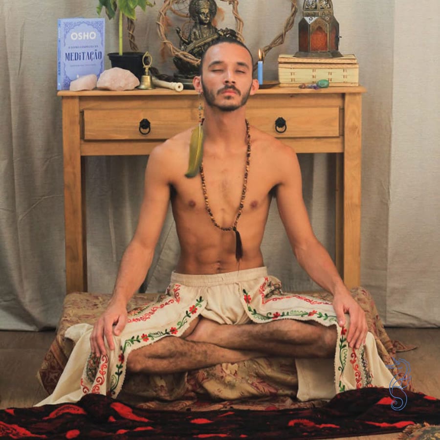 Gaspar meditando de olhos fechados, sentado em posição de lótus